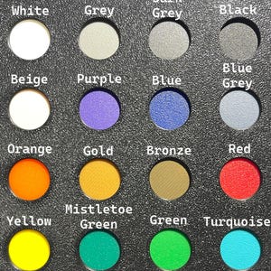 May include: A color palette featuring sixteen circular color samples, each labeled with a color name. Colors include white, grey, black, blue, orange, gold, red, yellow, green, and turquoise. The text labels are in white font.