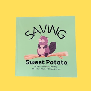 May include: A green book cover with the title "Saving Sweet Potato" written in black. The book cover features a cartoon beaver sitting on a branch.