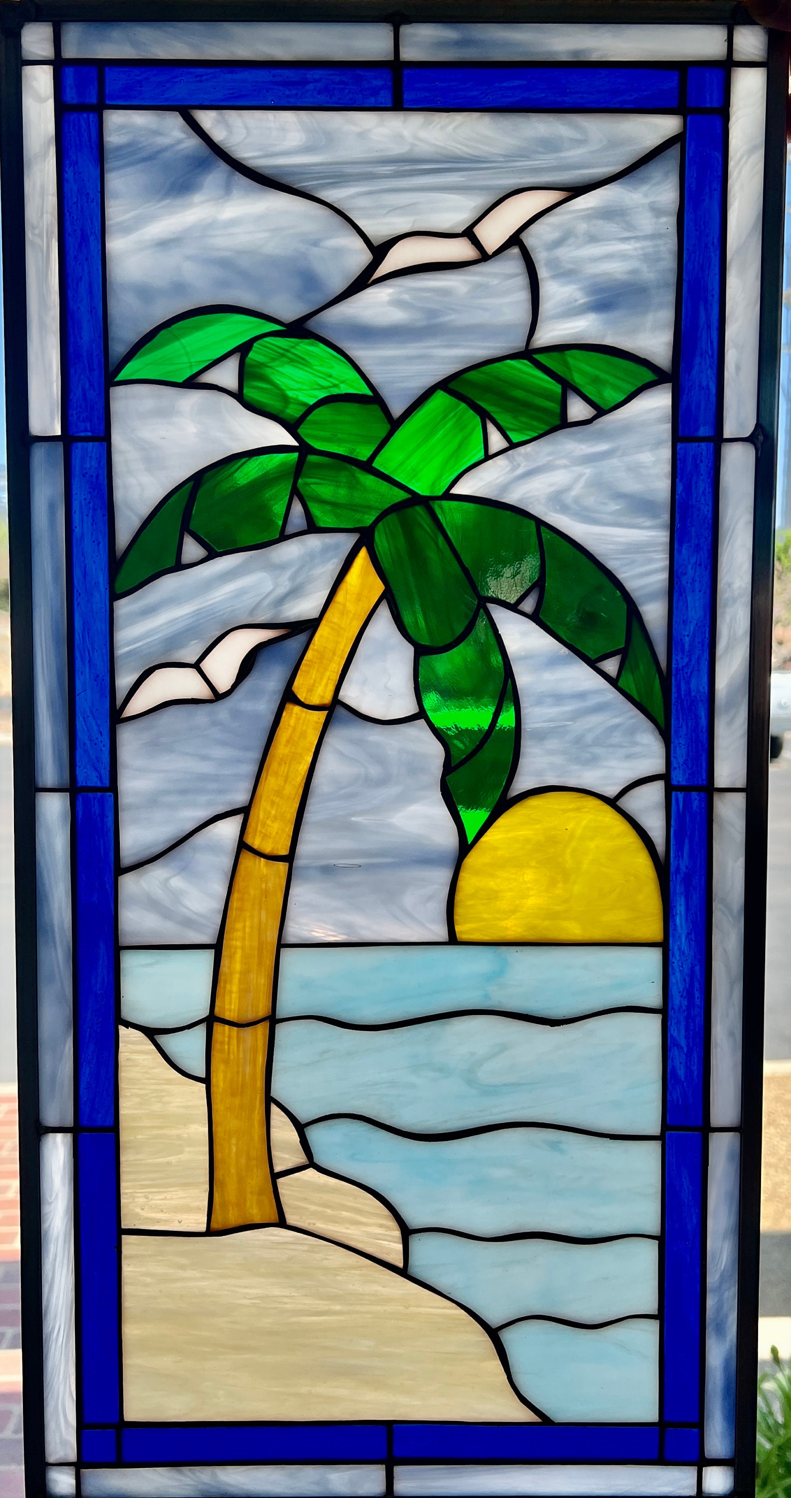 Stained glass window art of a mangrove tree in an ocean with purple and  pink flowers around the borders on Craiyon