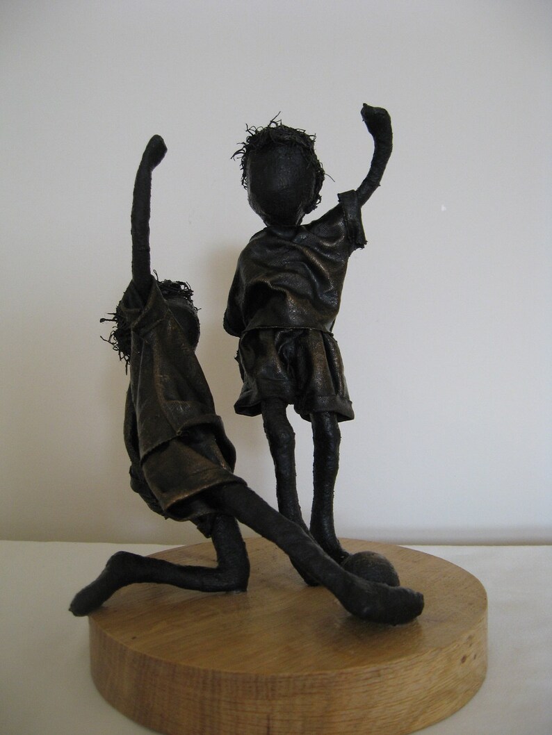 Sculpture of boys playing football Sculpture of footballer Little Footballers Made to order