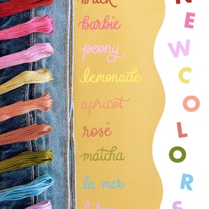May include: A close-up of a denim fabric with embroidery floss in various colors, including brick, barbie, peony, lemonade, apricot, ros&eacute;, matcha, la mer, and lilac. The text "NEW COLORS" is written in a wavy font on a yellow background.