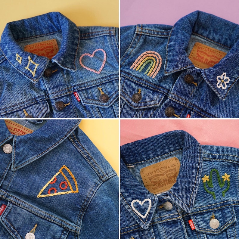 Puede incluir: Cuatro chaquetas vaqueras con diferentes dise&ntilde;os bordados. Los dise&ntilde;os incluyen un coraz&oacute;n, un arco&iacute;ris, una rebanada de pizza y un cactus con flores. Cada chaqueta tiene una etiqueta de Levi Strauss & Co.
