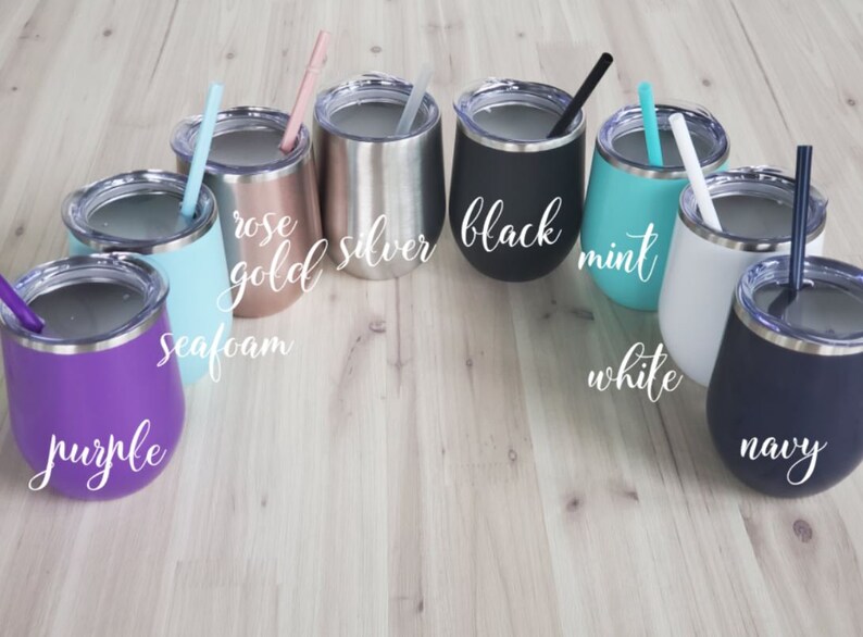 May include: A collection of insulated stemless wine tumblers in various colors, including purple, seafoam, rose gold, silver, black, mint, white, and navy. Each tumbler has a matching straw and the color name is written on the side.
