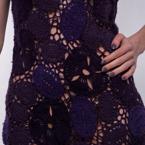 May include: A purple crochet dress with a floral pattern. The dress is made of a lightweight, breathable fabric and has a loose, flowy fit.
