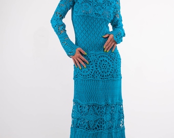 May include: A long, turquoise crochet dress with a delicate floral pattern and a flowing skirt.