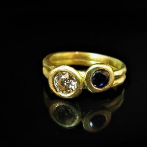 Engagement rings. combination of 2 rings. 18K Yellow gold ring with 1.00ct Diamond & 18K Yellow gold ring with 0.50ct Sapphire.