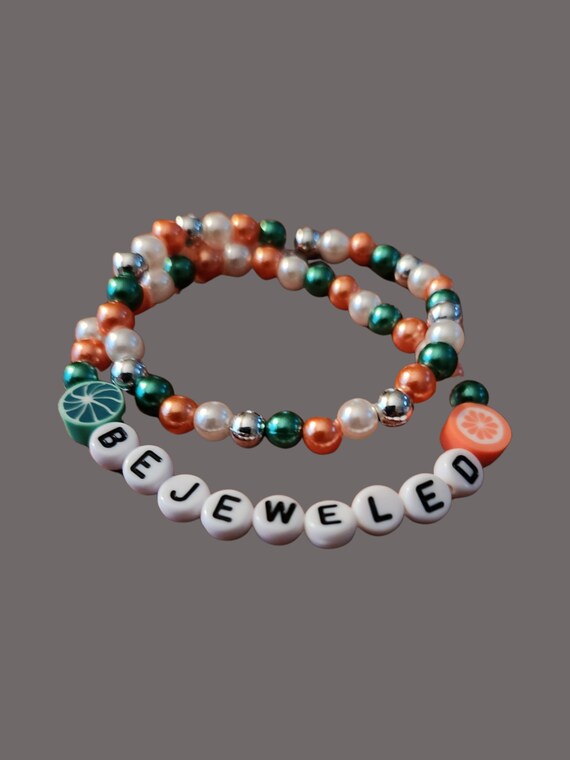2 stacked beaded Taylor Swift inspired bracelets which spells out Bejeweled