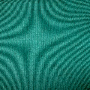 May include: Close-up of a textured, teal corduroy fabric. The fabric has vertical ridges, creating a ribbed effect. The color is a deep, saturated teal, with subtle variations in tone across the surface.