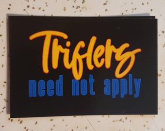 May include: Black sticker with the text "Triflers need not apply" in yellow and blue lettering.