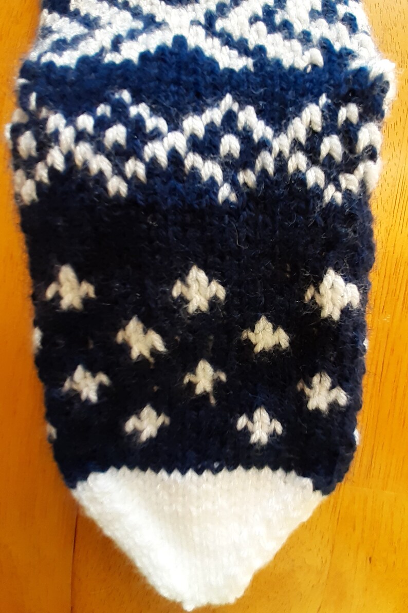 Hand knit blue and white Christmas Stocking with snowflake pattern