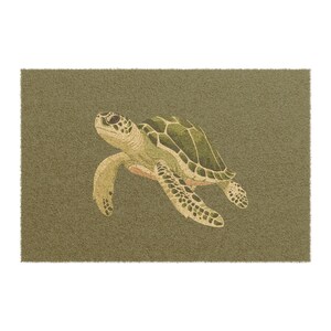 May include: A rectangular doormat with a detailed illustration of a sea turtle. The turtle is in shades of green, beige, and brown, with a textured shell and flippers. The background is a solid olive green.