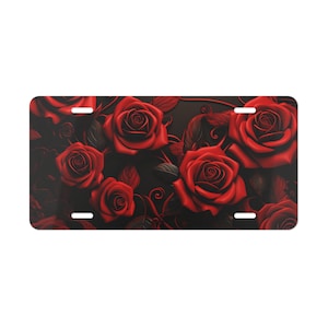 May include: A black background with a design of red roses and leaves. The roses are in full bloom and have a 3D effect.