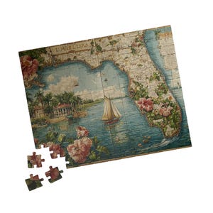 May include: A Florida-themed jigsaw puzzle with a vintage map design. The puzzle features a detailed illustration of the Florida coastline, adorned with floral accents and a sailboat on the water. Several puzzle pieces are separate.