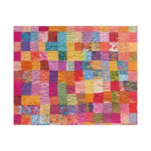 May include: A colorful patchwork quilt with a vibrant mix of squares in shades of pink, orange, yellow, green, and blue. The quilt features a variety of textured fabrics and patterns, creating a visually rich and cozy textile. The quilt is rectangular.