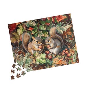 May include: A jigsaw puzzle featuring a watercolor illustration of two squirrels holding acorns amidst autumn leaves. The squirrels are brown and gray, with fluffy tails. The puzzle pieces are scattered at the bottom.