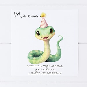 May include: A birthday card featuring a green snake wearing a pink and white party hat. The card says "Wishing a very special grandson a happy 5th birthday".