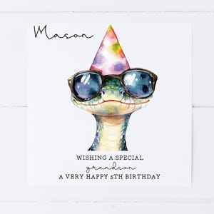 May include: A birthday card featuring a cartoon snake wearing sunglasses and a party hat. The card says "Wishing a special grandson a very happy 5th birthday".