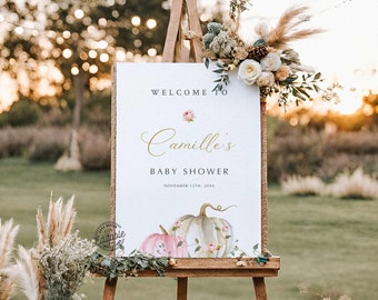 Op de afbeelding: Welkom bij Camille's Baby Shower bord met een aquarel-illustratie van pompoenen en bloemen. Het bord staat op een ezel en heeft de datum 12 november 20XX.