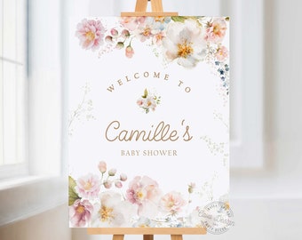May include: A white welcome sign with a floral design in shades of pink, blue, and green. The sign reads "Welcome to Camille's Baby Shower".