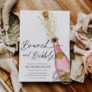 May include: A watercolor illustration of a champagne bottle with a cork popping and a splash of gold. The text reads "Brunch and Bubbly" and includes details for a bridal brunch. The text also includes the words "Cava Design 100% Editable Text Invitations".