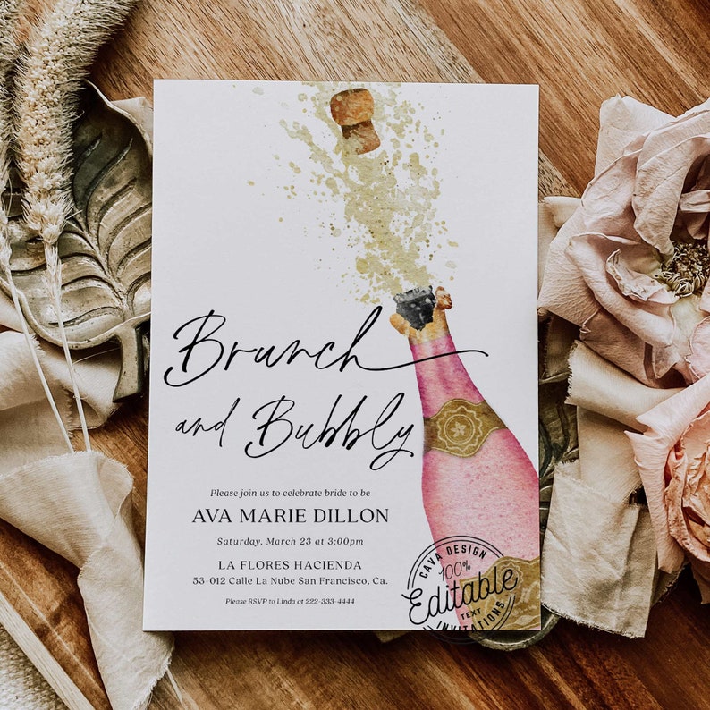 May include: A watercolor illustration of a champagne bottle with a cork popping and a splash of gold. The text reads "Brunch and Bubbly" and includes details for a bridal brunch. The text also includes the words "Cava Design 100% Editable Text Invitations".
