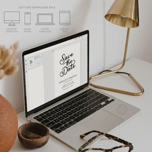 May include: A laptop computer displaying a save the date card with the text "Save the Date" in a black script font. The card is for Camille & Jonathan and the date is March 2, 2024. The laptop is on a white desk with a gold lamp and a vase with dried flowers.