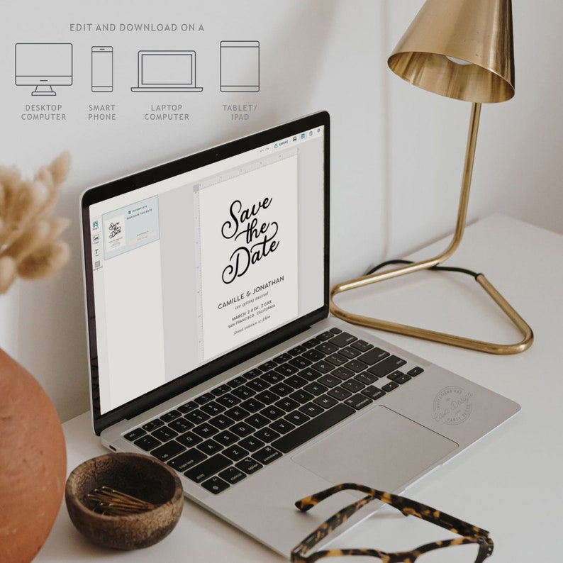 May include: A laptop computer displaying a save the date card with the text "Save the Date" in a black script font. The card is for Camille & Jonathan and the date is March 2, 2024. The laptop is on a white desk with a gold lamp and a vase with dried flowers.