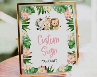 May include: A framed custom sign with a gold metal frame. The sign features a watercolor design with a zebra, giraffe, and lion. The sign is surrounded by tropical leaves and flowers. The text on the sign reads "Custom Sign" and "YOU EDIT".
