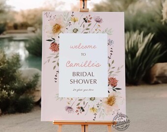 May include: A pink welcome sign with a floral design and the text "Welcome to Camille's Bridal Shower. I'm glad your here."
