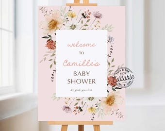 May include: A pink welcome sign with a floral design and the text "welcome to Camille's Baby Shower I'm glad your here". The sign is on a wooden easel.