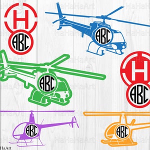 May include: A collection of helicopter designs in various colors, including blue, green, purple, and orange. Each helicopter features a circular monogram with the letters "ABC". Two designs also include a red circle with the letter "H". The background is a light wood grain.