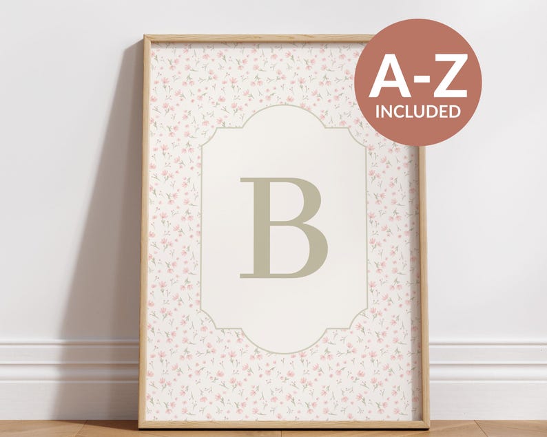May include: Framed floral print featuring a large letter "B" in a light green hue, set against a cream-colored background with a decorative border. The background is covered in a delicate pink floral pattern. A round sticker with the text "A-Z INCLUDED" is in the upper right corner.