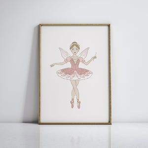 May include: A framed print featuring a whimsical illustration of a ballerina fairy. The fairy is depicted in a pink tutu, wings, and pointe shoes, holding a wand. The artwork is set against a white background, framed in gold.