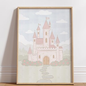 May include: A framed illustration of a pink castle with multiple turrets, flags, and a stone pathway leading to the arched wooden door. The castle is set against a light blue sky with white clouds and green hills.