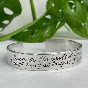 May include: Silver bracelet with the inscription "because He bends down to me I will pray as long as I have breath".