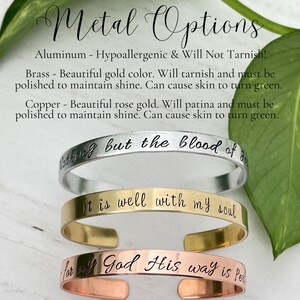 May include: Three metal cuff bracelets in silver, gold, and copper. Each bracelet has an engraved inspirational quote. The top bracelet is silver and reads "Nothing but the blood of Jesus." The middle bracelet is gold and reads "It is well with my soul." The bottom bracelet is copper and reads "for all God His way is perfect."