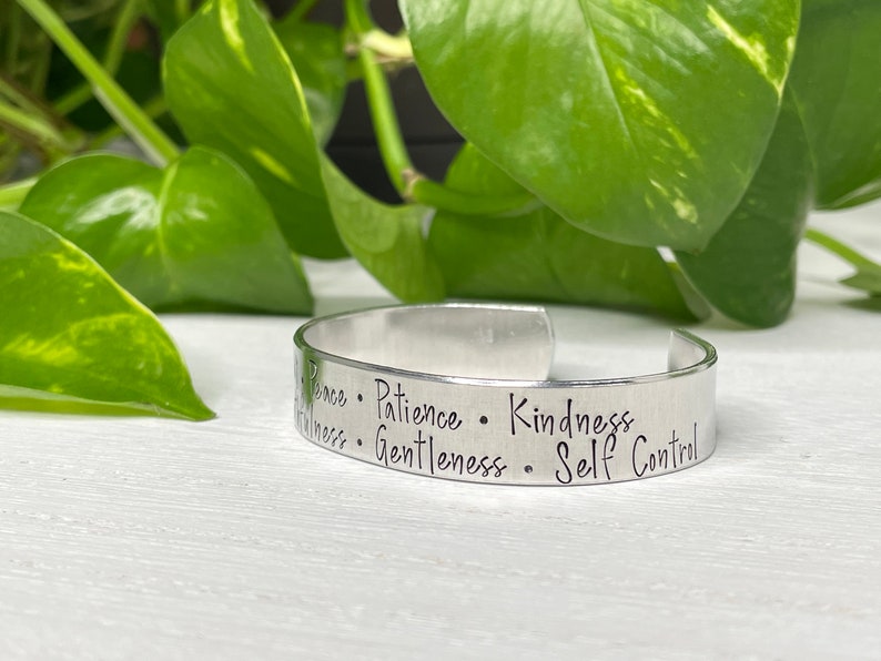 May include: Silver bracelet engraved with the words "Peace, Patience, Kindness, Gentleness, Self Control".