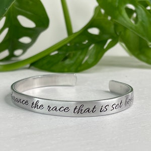 May include: Silver bracelet with the inscription "Endurance the race that is set before you".