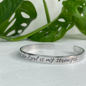 May include: Silver bracelet with the inscription "The Lord is my Strength".