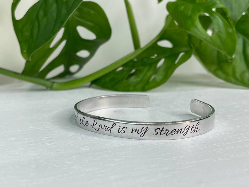 May include: Silver bracelet with the inscription "The Lord is my Strength".