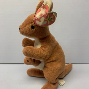 May include: Brown and white plush kangaroo beanie baby toy with a red tag that says "Beanie Original Baby".