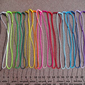May include: Twenty-one cords of different colors, including black, brown, white, lime green, emerald green, sea-green, gold, yellow, orange, hot pink, pink, light pink, red, crimson, blue, light blue, dark blue, turquoise, lilac, and purple.