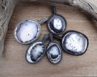 May include: Five pendants with black and white agate stones, each wrapped in a crocheted cord. The cords are in shades of gray and black.