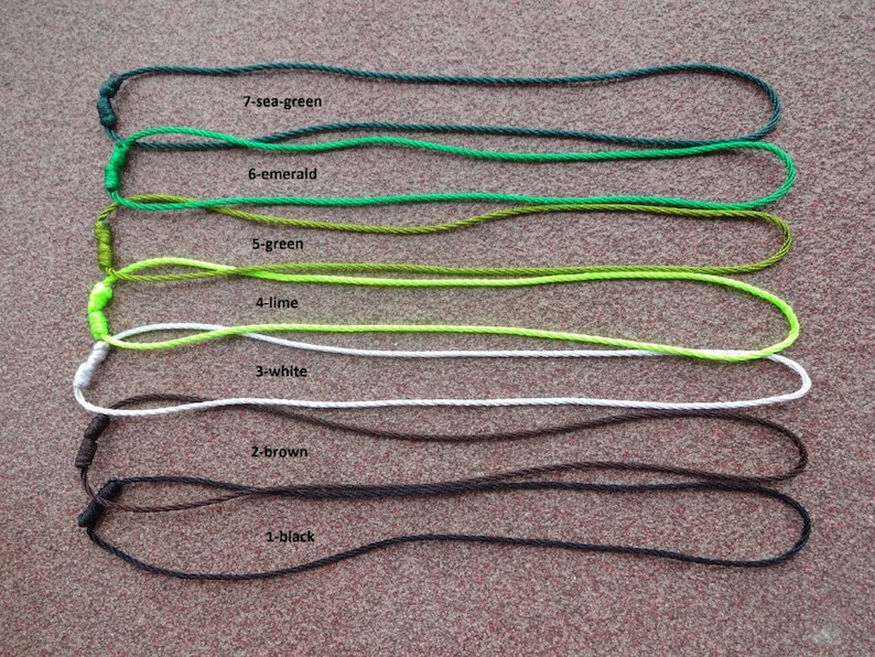 May include: Seven different colors of cord, each tied in a loop. The colors are sea green, emerald green, green, lime green, white, brown, and black. The cords are labeled with their color and number.