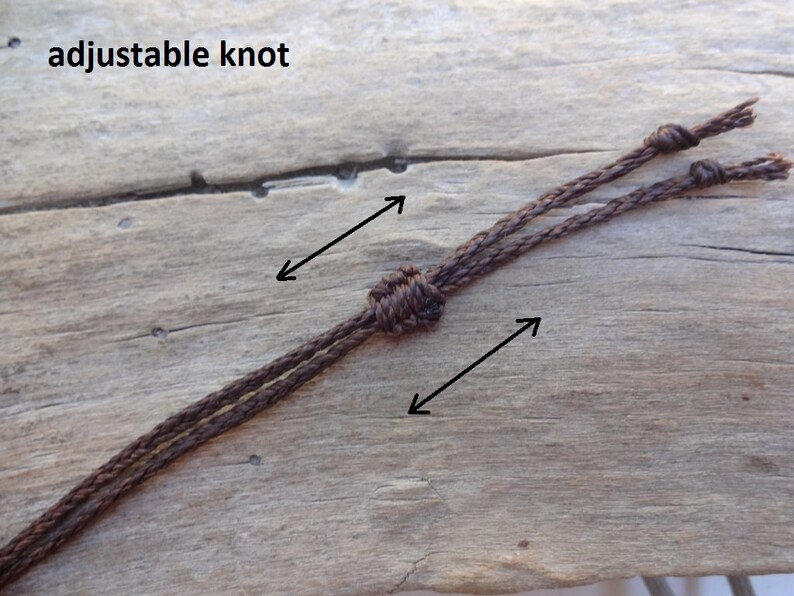 May include: A close-up of a brown cord with an adjustable knot. The cord is tied with two knots, one at each end. The text "adjustable knot" is written in black letters at the top of the image.