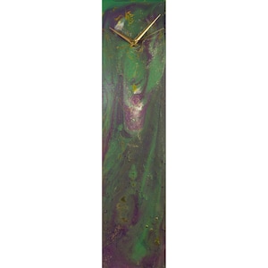 May include: A long, rectangular clock with a green, purple, and gold abstract design. The clock face is white with gold hands.