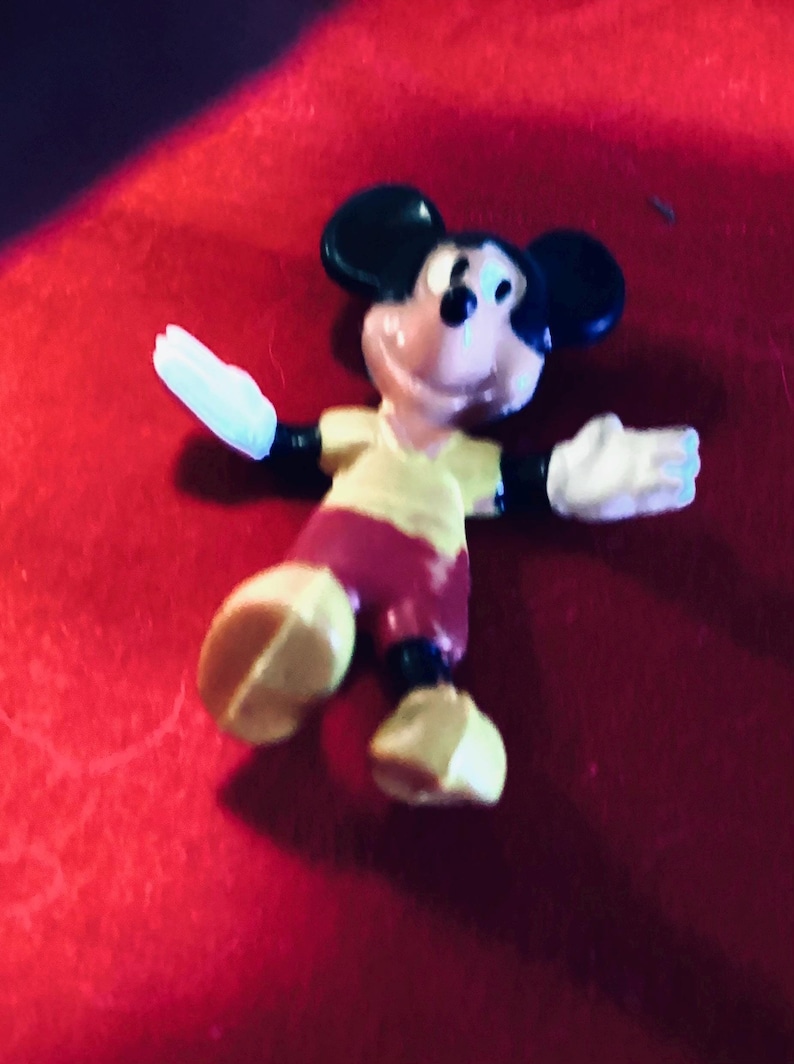 Mickey Mouse, small rubber figuring made in Hong Kong for Walt Disney productions in the 1960s. The rubber has a wire framework. Typical colors with Mickey, wearing yellow shirt yellow shoes and red pants. This little figuring is 2 1/2 inches high.
