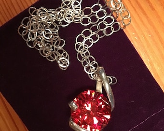 Vintage huge diamond cut bright orange red Swarovski pendant on long silver chain.