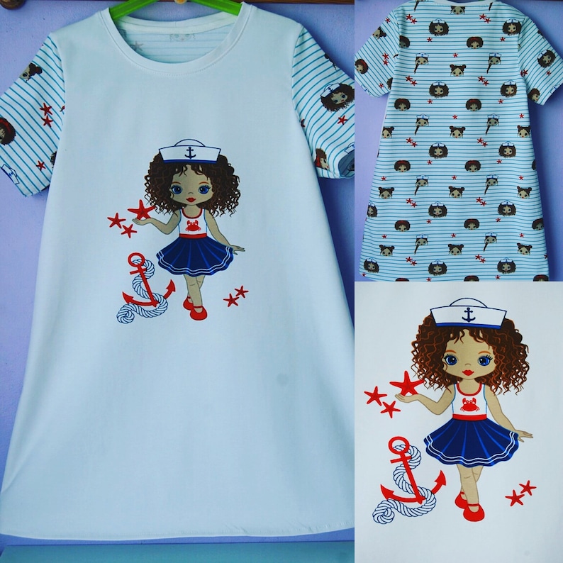 May include: White t-shirt with a blue and white striped sleeve. The front of the shirt features a cartoon girl wearing a sailor hat and holding a star. The girl is standing next to an anchor.