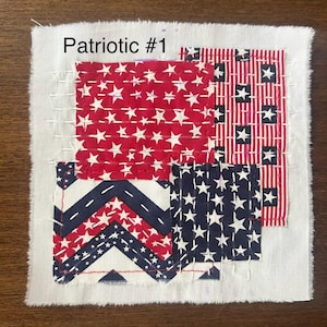 May include: A square fabric piece with a patchwork design featuring red, white, and blue patterns. The design includes stars, stripes, and chevron patterns, with the text "Patriotic #1" at the top.